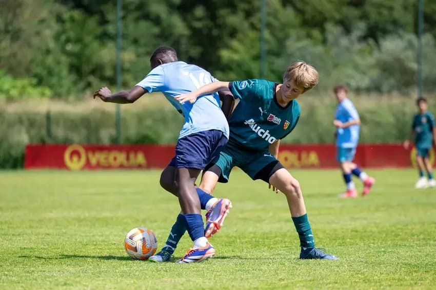 Players in a group conversation with the coaching staff
